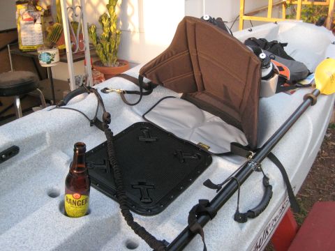 1953 Ford Mainline - A kayak is prepared for use with a paddle, seat, and a cold beverage ready.