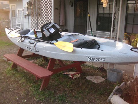1953 Ford Mainline - A kayak rests on a picnic table outside a house.