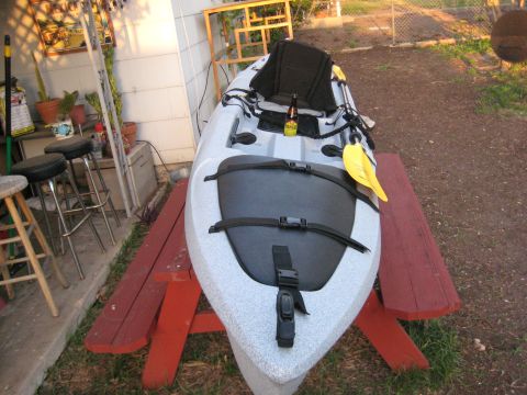 1953 Ford Mainline - Kayak resting on a picnic table, with a beer and paddle onboard. Background shows outdoor patio area.
