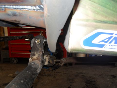 1997 Ford Ranger - Detail of vehicle suspension components and a sticker on a metal enclosure.