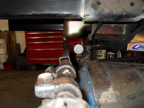 1997 Ford Ranger - Undercarriage view of a vehicle, possibly undergoing maintenance, with a red toolbox in the background.