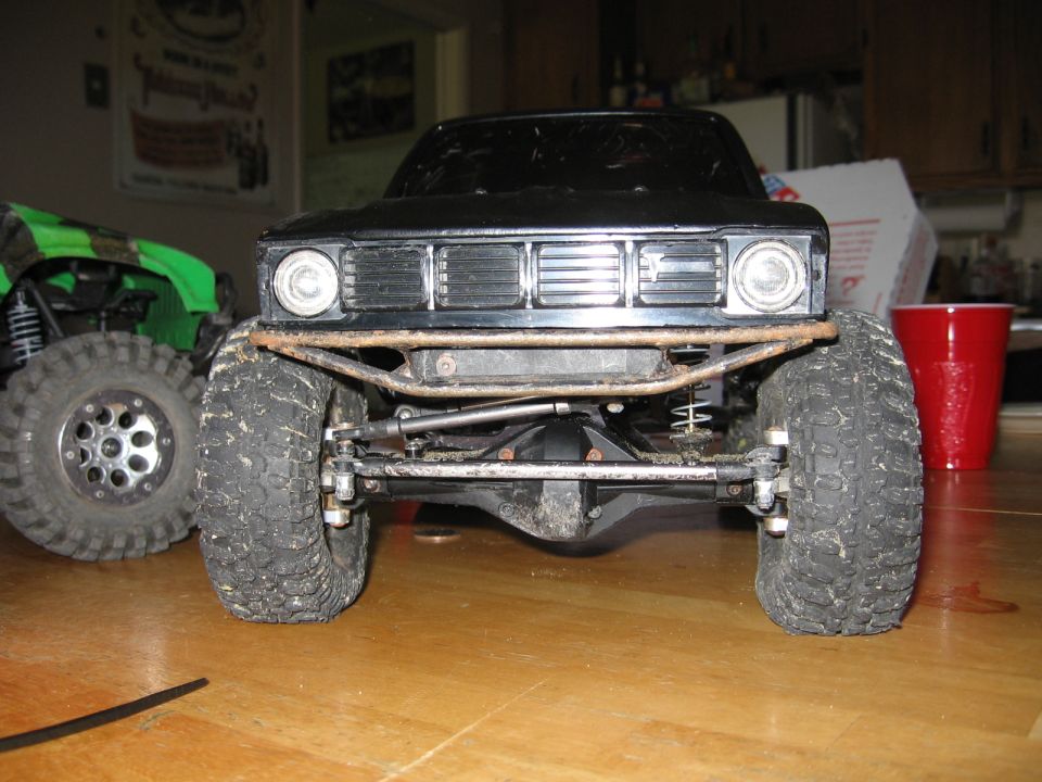 Black toy truck front view with off-road tires and custom bumper