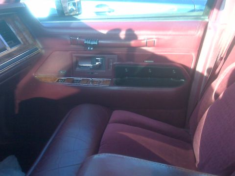 1993 Lincoln Town Car - Interior view of a 1993 Lincoln Town Car, focusing on the door panel and seat.