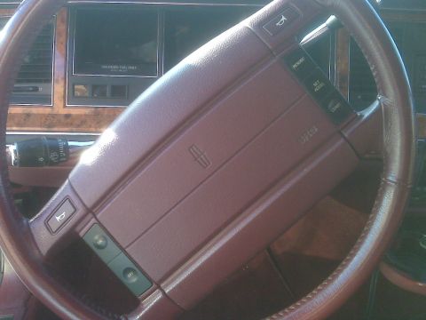 1993 Lincoln Town Car - Interior view of a 1993 Lincoln Town Car, focusing on the steering wheel and dashboard details.