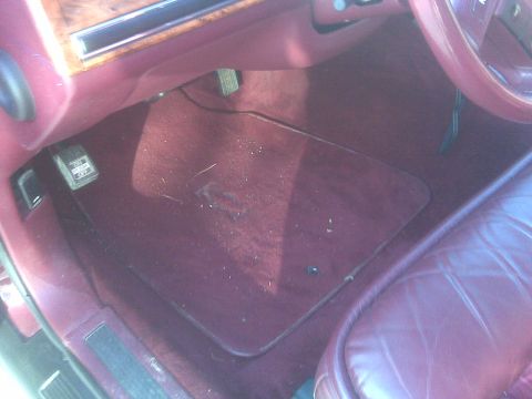 1993 Lincoln Town Car - Interior view of a 1993 Lincoln Town Car, showing the maroon carpet and seating.
