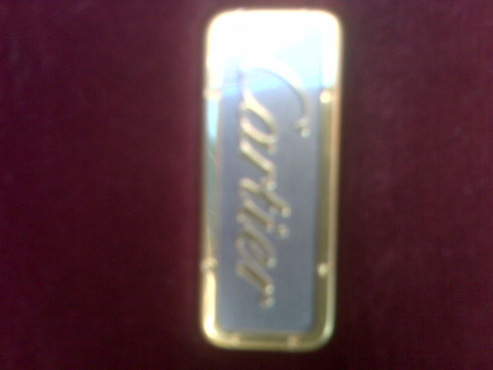 gold and blue Cartier lighter