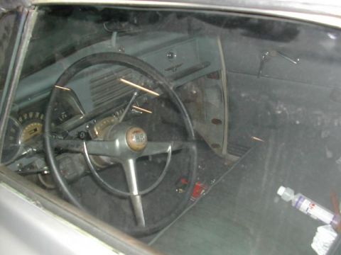 1991 Ford Crown Victoria - The interior of a classic car is visible through the windshield, showing the dashboard and steering wheel.