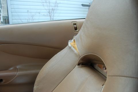 1996 Ford Probe - Interior view of a car seat showing significant wear and tear on the upholstery.