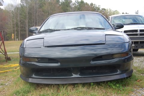 1996 Ford Probe - Front view of a 1996 Ford Probe, with a Dodge Ram visible behind it.