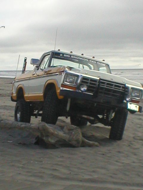 1978 Ford Bronco - Ford Bronco on beach with "2 BIG BRONCOS 4X4 CLUB" banner visible.