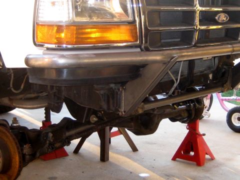 1996 Ford Bronco - Front end of a 1996 Ford Bronco, modified with a custom bumper and supported by jack stands.