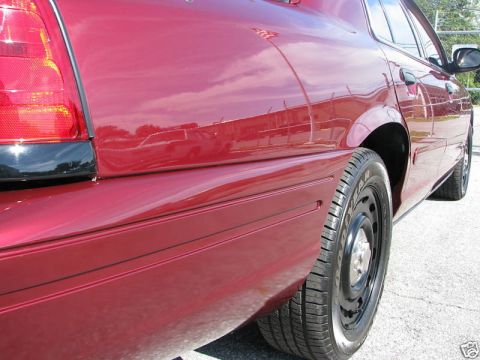 2005 Ford Crown Victoria - Rear side view of a red 2005 Ford Crown Victoria sedan.