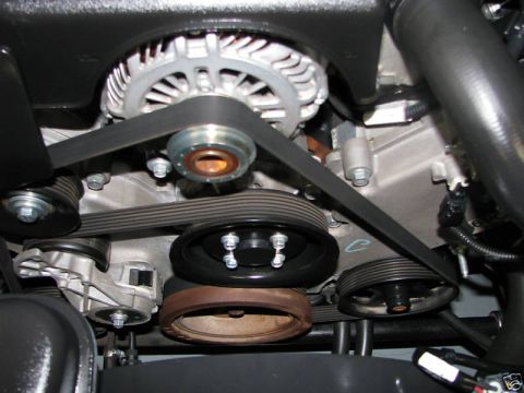 2005 Ford Crown Victoria - Close-up view of the engine's serpentine belt and pulley system.