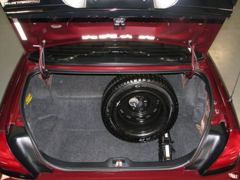2005 Ford Crown Victoria - Trunk interior of a 2005 Ford Crown Victoria, complete with spare tire and jack.