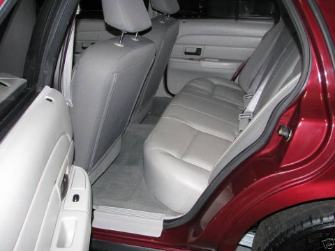 2005 Ford Crown Victoria - The interior of a red 2005 Ford Crown Victoria, viewed from the rear passenger side.
