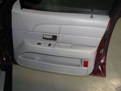 2005 Ford Crown Victoria - Close-up view of the interior door panel, showing the armrest and storage compartment.