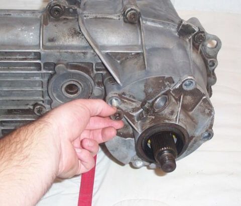 1990 Ford Bronco - Now remove the bolts which hold the rear tailshaft housing on