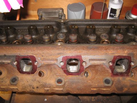 1994 Ford Bronco - Close-up of a used engine cylinder head, showing exhaust ports and valve stems.