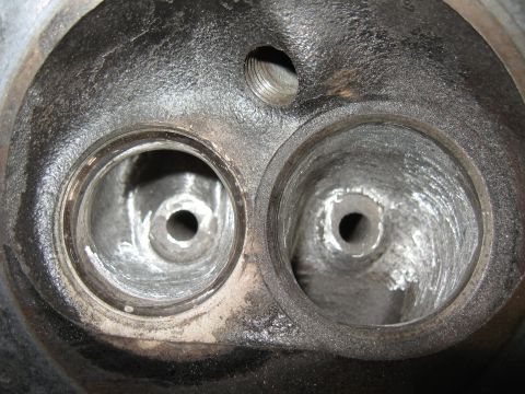 1994 Ford Bronco - Close-up view of an engine cylinder head, showing two valve openings and signs of use.