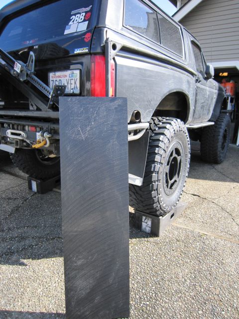 1996 Ford Bronco - Rear view of a black 1996 Ford Bronco, modified with off-road tires and a lifted suspension.