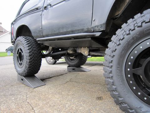 1996 Ford Bronco - This modified Ford Bronco, likely from the early to mid-1990s, is shown from the side on car ramps.