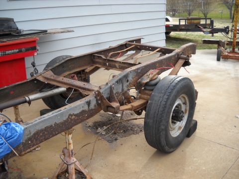 1954 Ford F-100 - Truck chassis on jack stands, showing suspension components and frame rust.