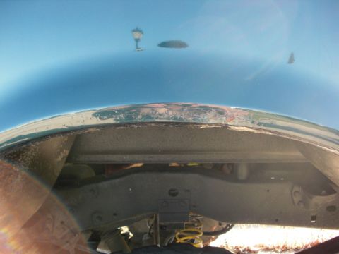 1995 Ford F-150 - Underside view of a vehicle's fender well, revealing suspension and frame details.