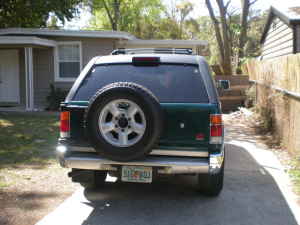 1993 Isuzu Rodeo - This SUV is parked in a residential driveway. The spare tire is mounted on the rear door.