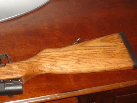 1989 Ford Bronco - Close-up view of the wooden stock and metal components of a rifle.