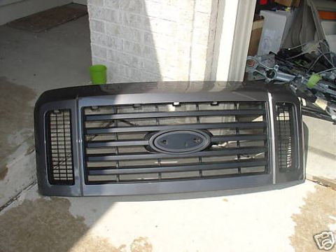 2008 Ford F-250 - A gray Ford F-250 grille is shown from the front, resting on a concrete surface.