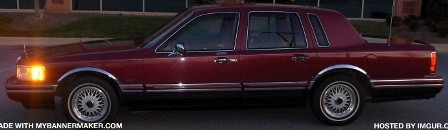 1993 Lincoln Town Car - Maroon 1993 Lincoln Town Car parked outdoors at dusk, showing its full side profile.