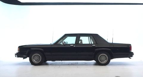1971 Ford Ranchero - Side profile of a black sedan, likely a 1980s Ford model.