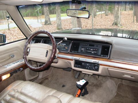 1971 Ford Ranchero - The interior of a 1991 Ford Crown Victoria, a tan dashboard and leather seats.