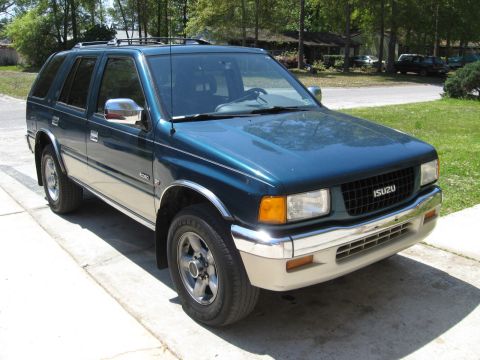 1993 Isuzu Rodeo - 1993 Isuzu Rodeo SUV shown from a 3/4 front angle on a sunny day.