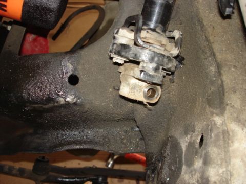 1992 Ford Bronco - Steering column joint assembly on a greasy metal frame.