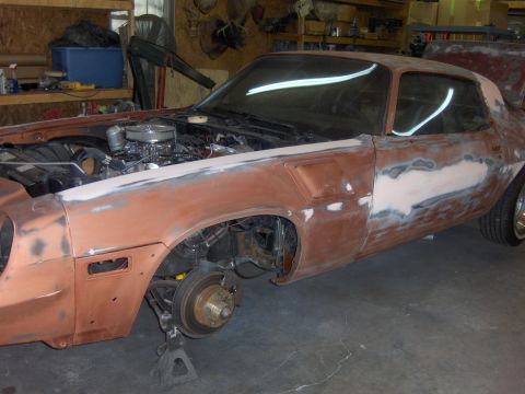 1980 Chevrolet Camaro - This car is undergoing body repairs, with the engine visible and one wheel removed.