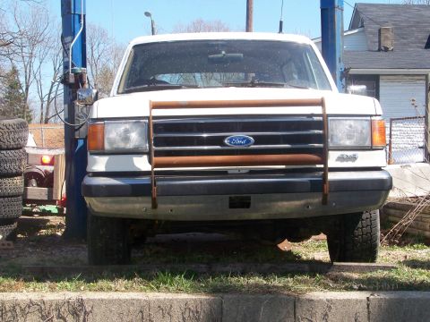 1989 Ford Bronco - Front view of a white 1989 Ford Bronco, equipped with a bull bar and parked outdoors.