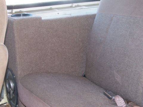 1989 Ford Bronco - A custom speaker box with a built-in cup holder is visible behind the passenger seat.