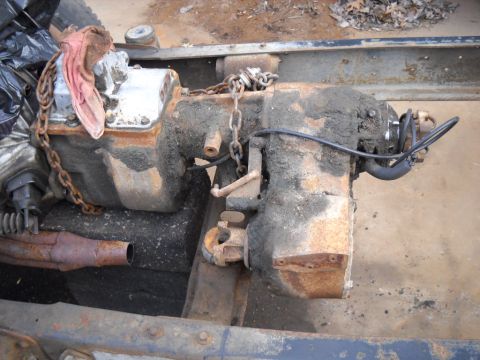 1954 Ford F-100 - This image shows a transmission and transfer case assembly, likely from a truck, covered in dirt and grime.