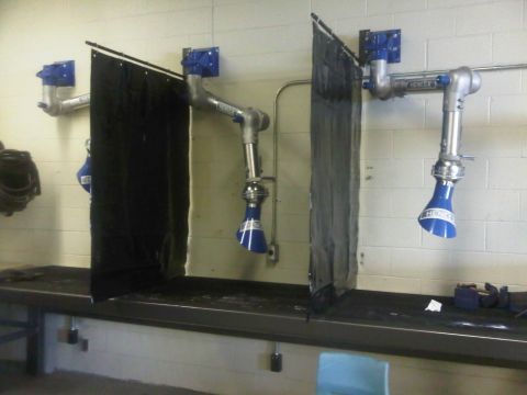 1996 Ford Bronco - Industrial workspace with fume extraction systems installed over a long workbench.