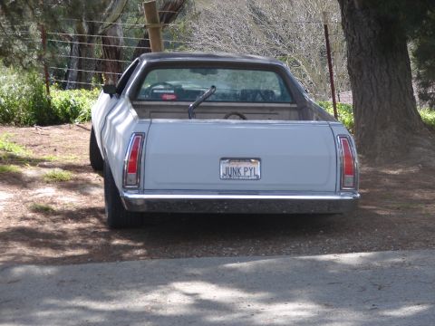 1973 Ford Ranchero - This 1972 Ford Ranchero pickup truck is parked outdoors near trees and a fence.