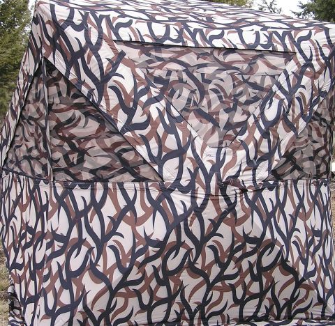 1996 Ford Bronco - A camouflaged tent is shown from the side, obscuring any view of a vehicle underneath.