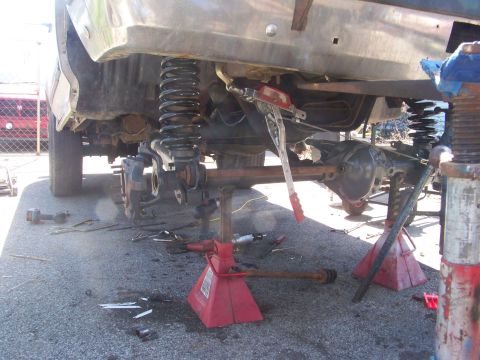 1989 Ford Bronco - Suspension work in progress on a vehicle, with the rear axle disassembled.