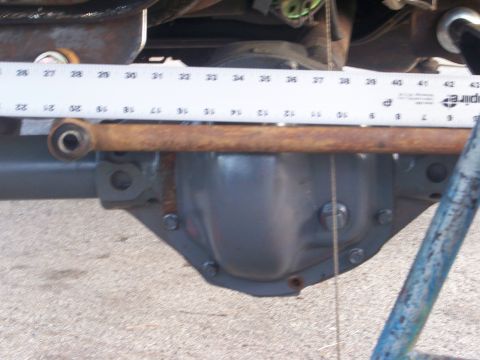 1989 Ford Bronco - A ruler is placed over a rear axle differential cover, indicating a measurement.