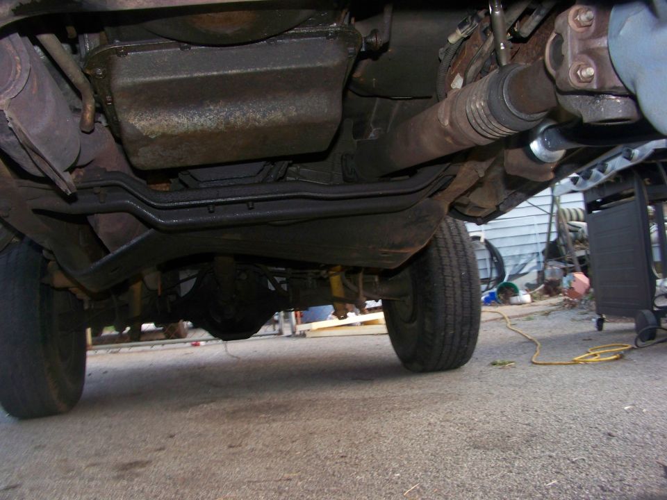 Underside of a vehicle showing drivetrain components and rear axle