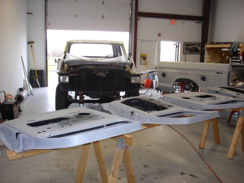 1979 Ford F-250 - A 1979 Ford F-250 crewcab is in a workshop, with its doors removed and laid out for restoration.