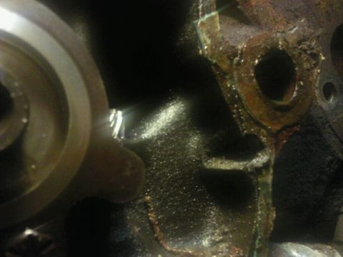 1995 Ford Bronco - Detail of a corroded engine block, showing damage and a metal component. Supermotors.net logo visible.