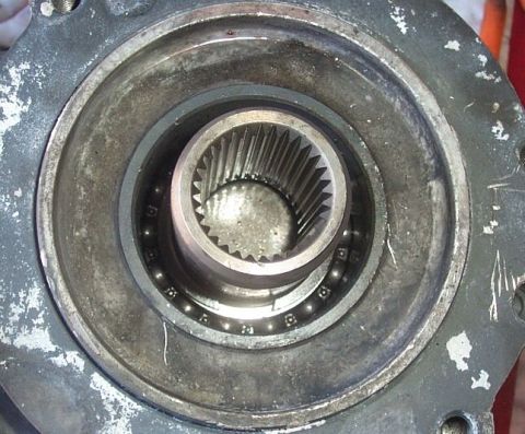 1990 Ford Bronco - Now flip the front case half over and pry out the front input seal to reveal this snap ring. Be certain you have a nice pair of duckbill sn…