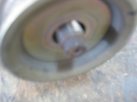1993 Honda Civic - Close-up view of an engine bay component, showing an exhaust pipe and a red spring, with visible dirt and grime.