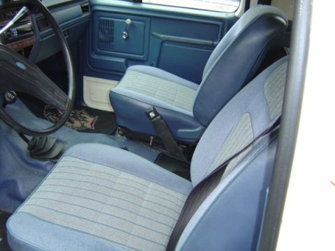 1985 Ford Bronco - View of the bare metal ceiling structure inside a vehicle, showing ribs and wiring.